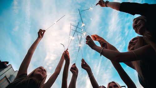 Low angle view of people against sky