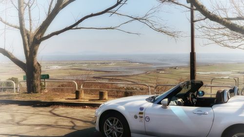 Car on landscape against sky