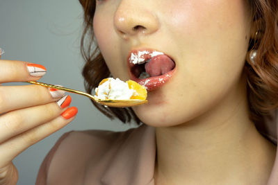 Midsection of woman eating ice cream