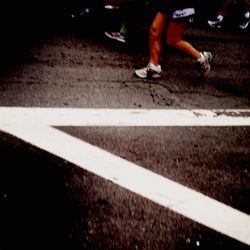 Low section of people walking on road