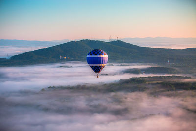 View of hot air balloon above clouds