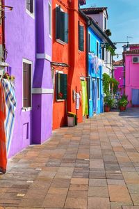 Multi colored buildings by street in city