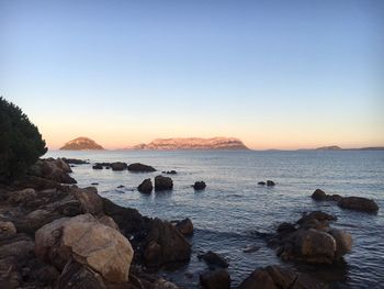 Scenic view of sea against clear sky at sunset