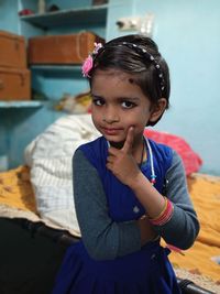 Portrait of cute girl sitting at home