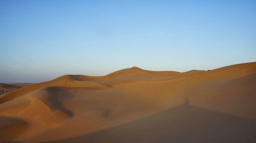 Scenic view of desert against clear sky