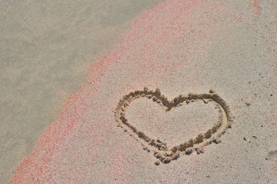 High angle view of heart shape on sand