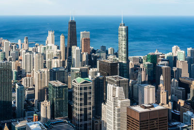 High angle view of buildings by sea against sky