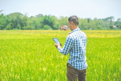 Side view of man using digital tablet