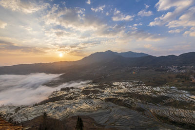 Scenic view of mountains against sky during sunset