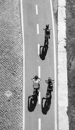 High angle view of bicycling on narrow road