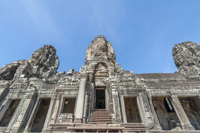 Low angle view of temple building against blue sky