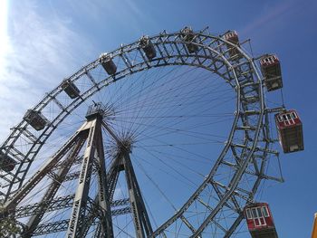 Low angle view of ferris wheel against sky