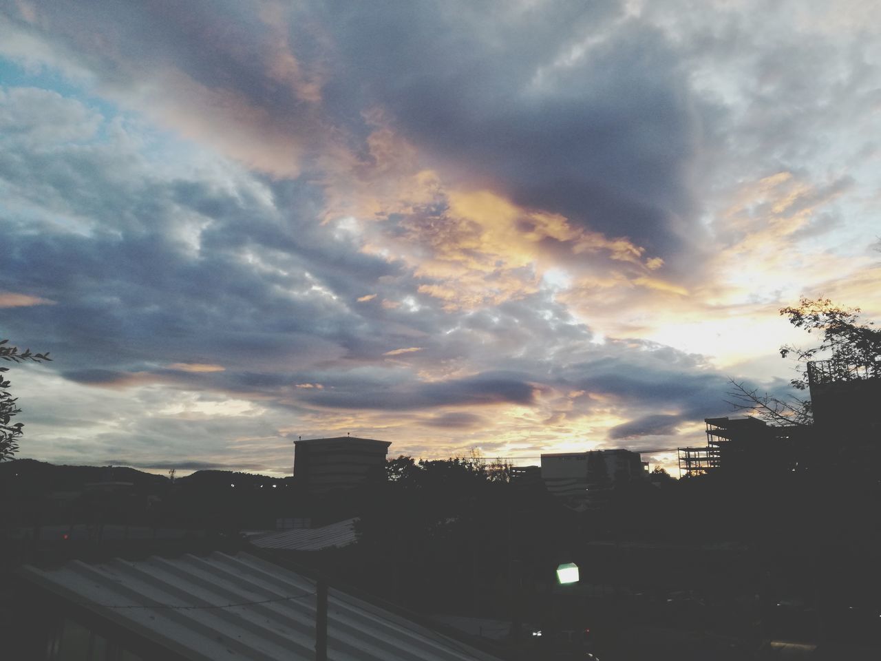 SILHOUETTE OF CITY AGAINST SKY DURING SUNSET