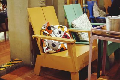 Close-up of chairs on table at beach