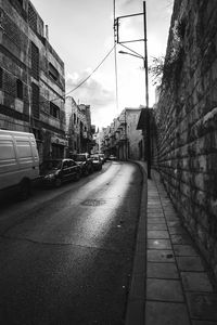 Street amidst buildings against sky in city