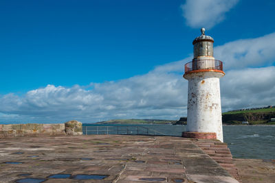 Lighthouse against cloudy sky