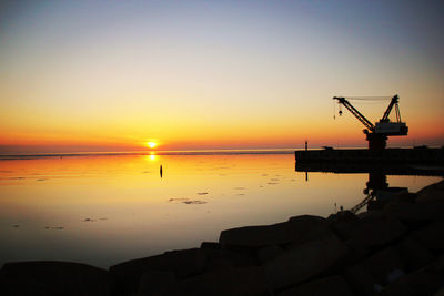 Scenic view of sea against clear sky during sunset