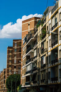 Low angle view of buildings against blue sky