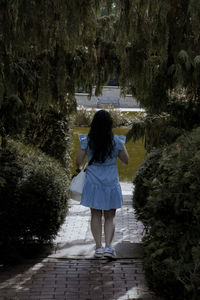 Rear view of woman standing in water