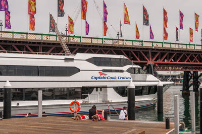 People at bus stop sign in city