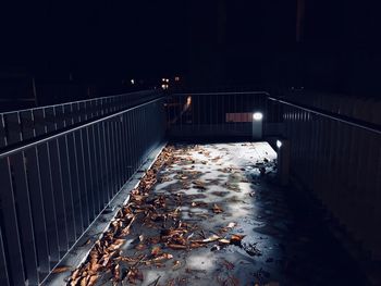 Illuminated bridge over water at night