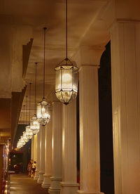 Low angle view of illuminated lamp hanging in built structure