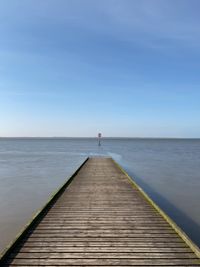 Pier over sea against sky