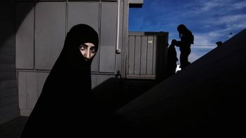 SILHOUETTE MAN AND WOMAN STANDING AGAINST WALL IN THE DARK