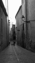 Narrow street along buildings