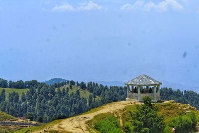 Scenic view of trees and mountain against sky
