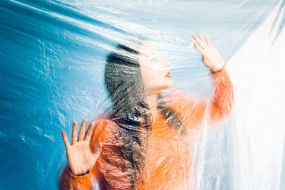 High angle view of woman hand in water