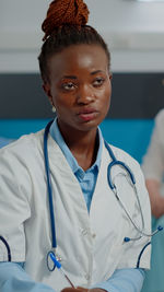 Portrait of female doctor standing in hospital
