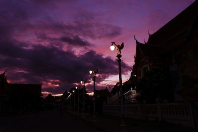 Low angle view of buildings against sky at sunset