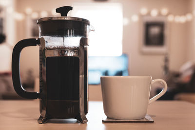 Close-up of coffee cup on table at home