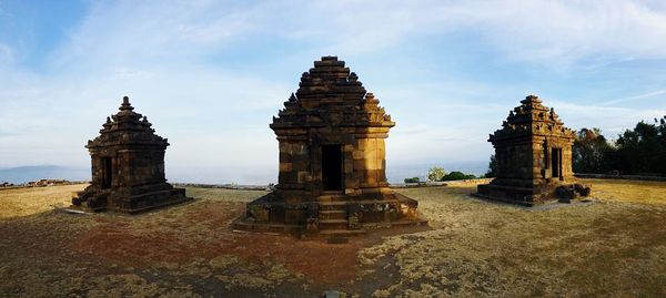 Ruins of temple against cloudy sky