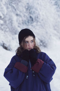 Portrait of woman standing in snow