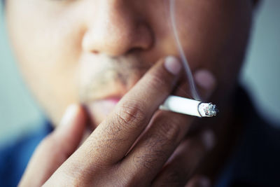 Midsection of man smoking cigarette