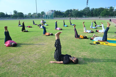 Group of people relaxing on field