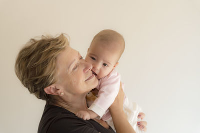 Portrait of happy mother and daughter against clear sky