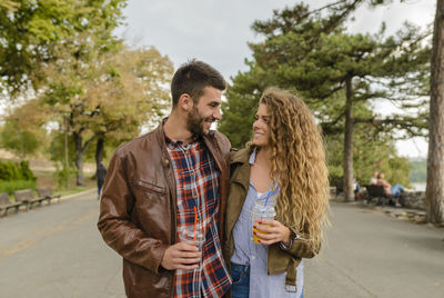 Couple on road against sky