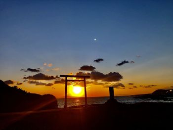 Scenic view of beach against sky during sunset