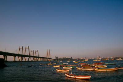 Boats in city against clear sky