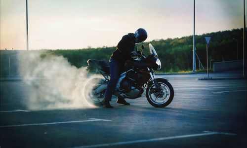 People riding motorcycle on road