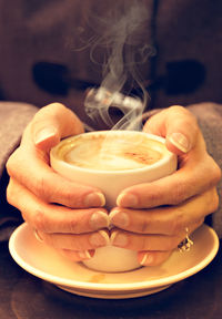 Close-up of woman holding coffee cup