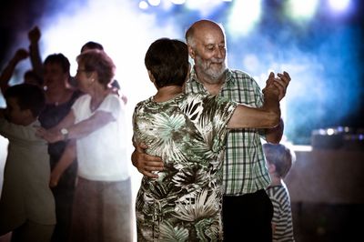 Close-up of couple dancing in party at night