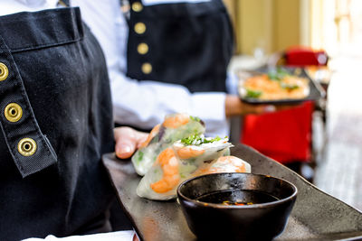 Close-up of man holding food on table