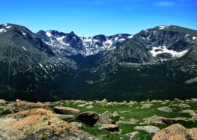 Scenic view of snowcapped mountains against blue sky