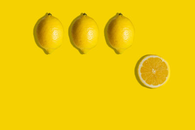 Close-up of fruits against yellow background