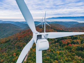 Close-up on the propellers of a wind turbine during a misty morning and sunrise. green energy. 