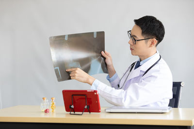 Midsection of man using smart phone